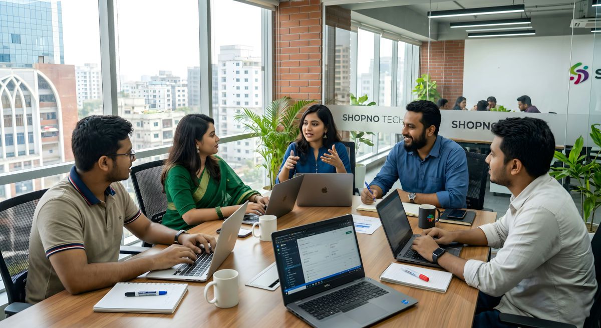 Design studio team collaborating around a table in a bright office