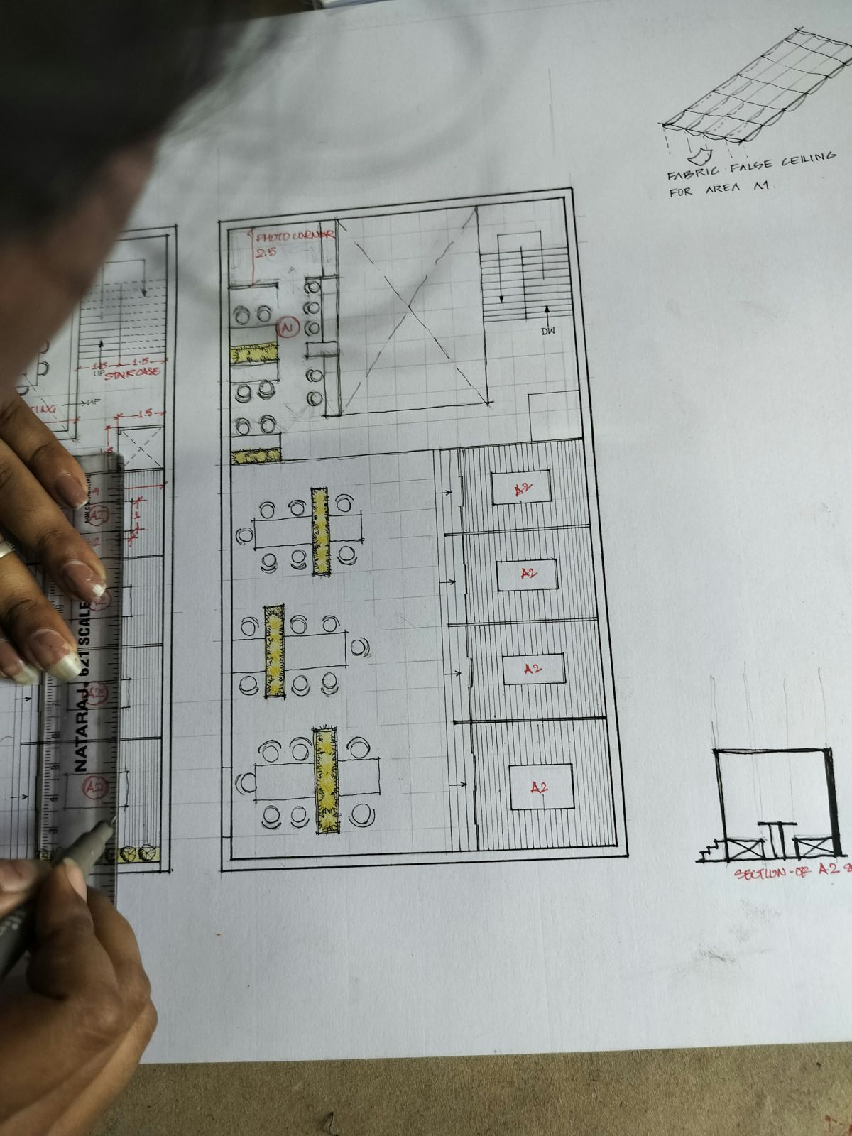 Architect marking a printed floor plan layout during design review