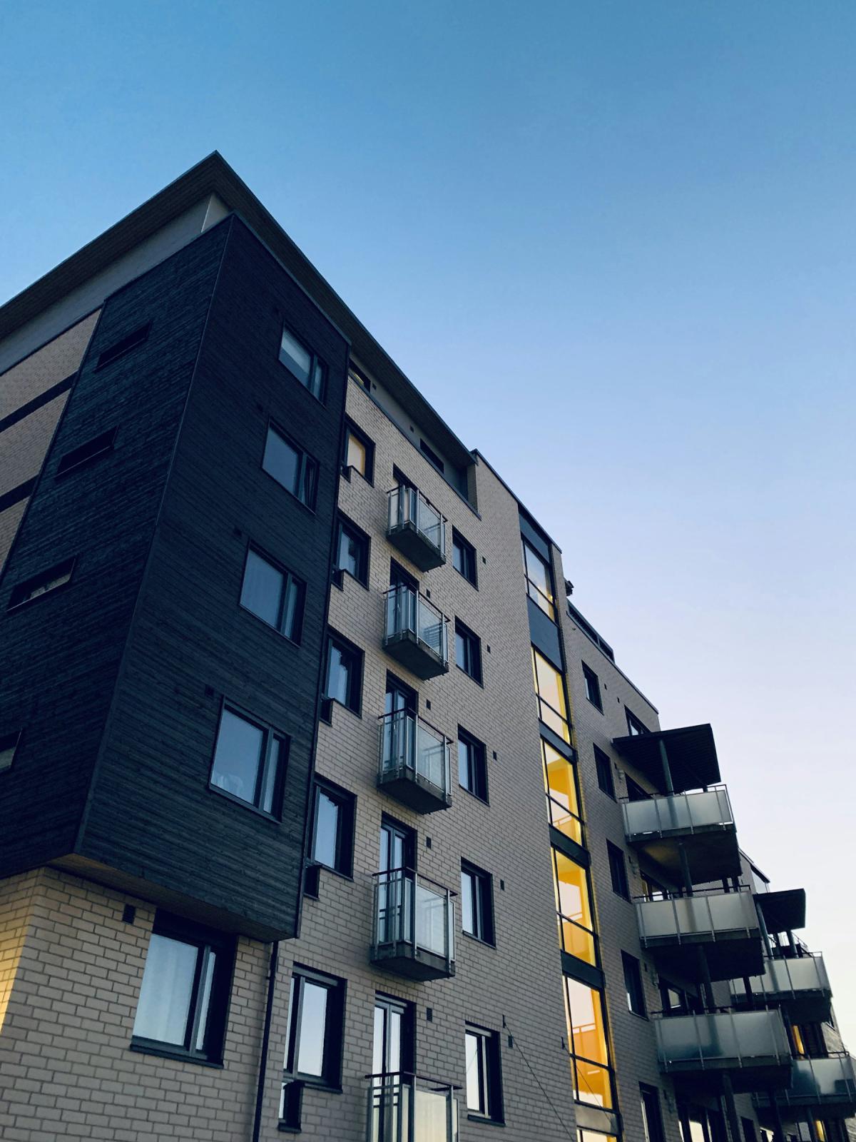 Apartment architecture with balconies and dark facade panels