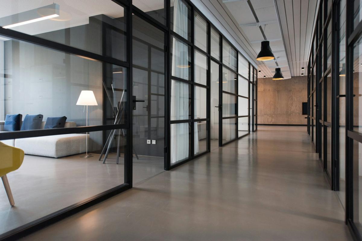 Glass-partitioned office workspace with clean corridors Glass-partitioned office workspace with clean corridors