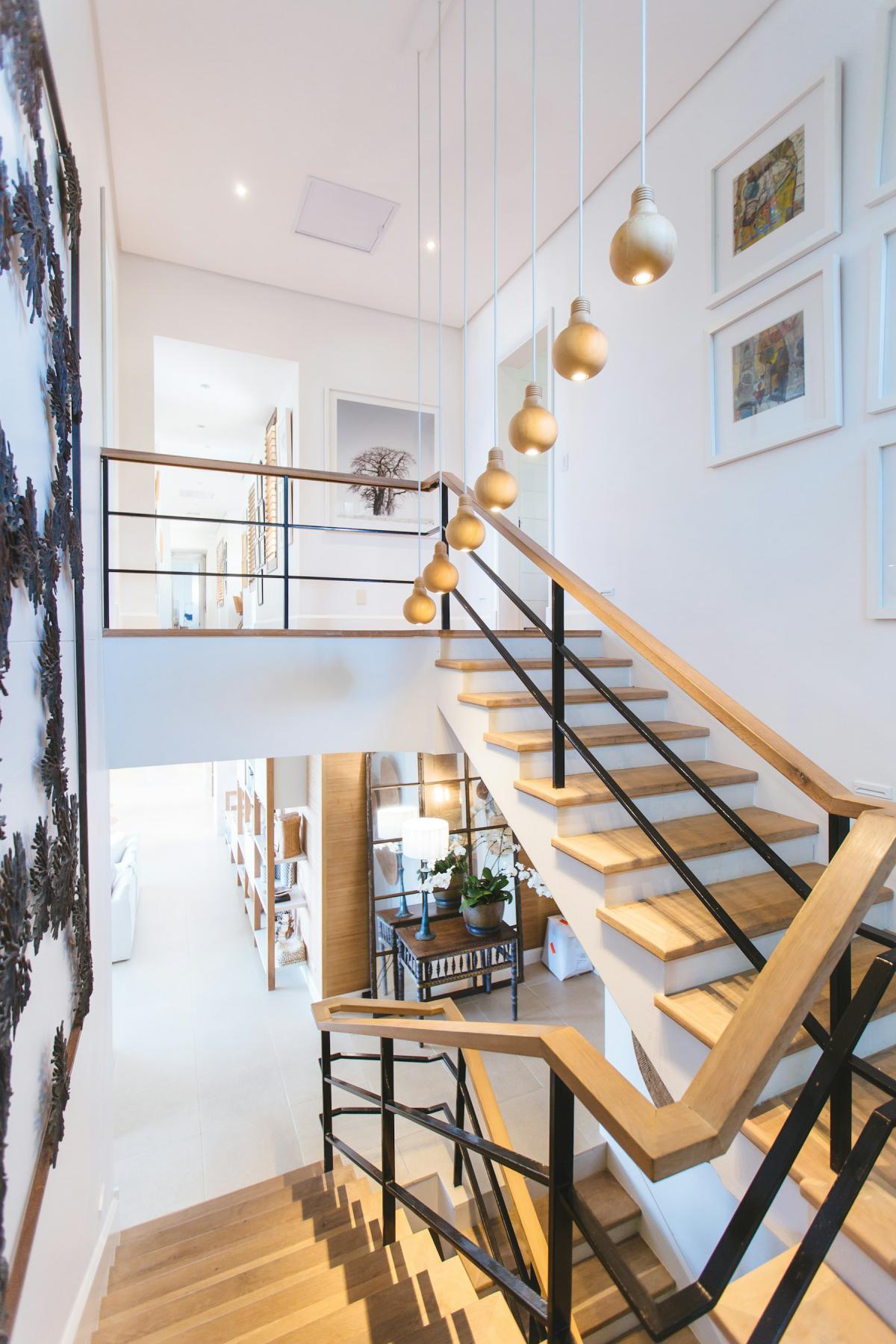 Lighting design with cascading pendant lights along a timber staircase