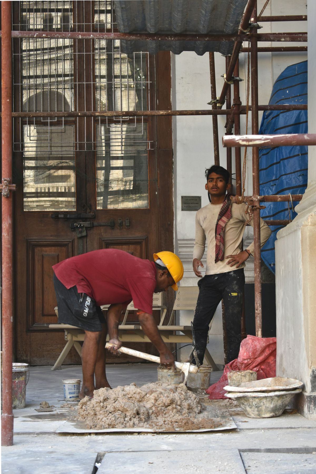 Site workers in safety helmets carrying out construction work in Hyderabad