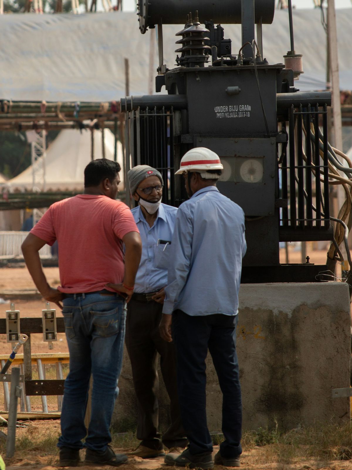 Site engineer in a safety helmet supervising work with the contractor team