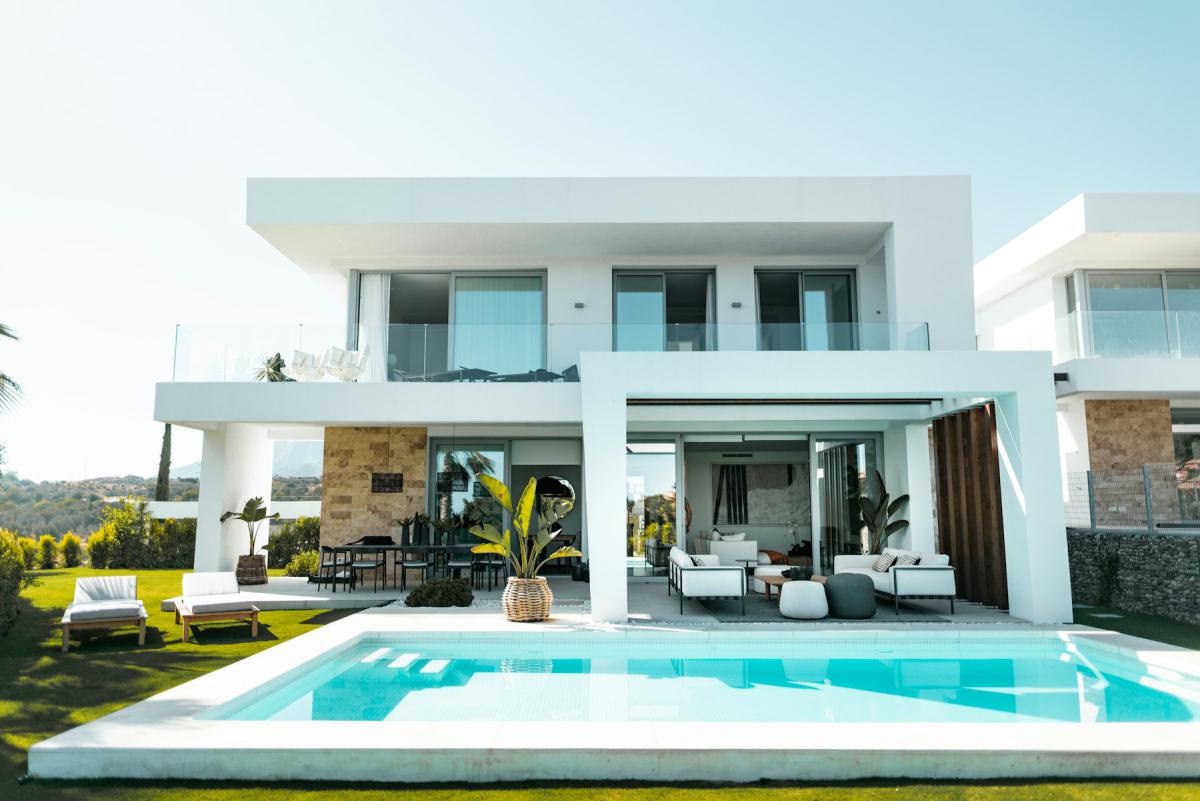 Luxury villa exterior with turquoise pool and landscaped deck Luxury villa exterior with turquoise pool and landscaped deck