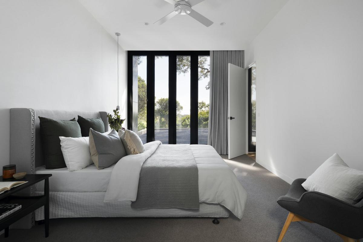 Villa bedroom interior with soft neutral palette and garden views Villa bedroom interior with soft neutral palette and garden views