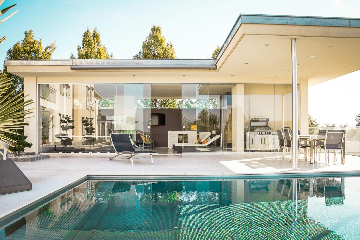 Villa courtyard with pool and expansive glazed living pavilion